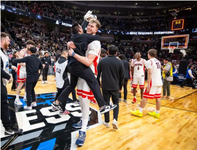 Motiejus Krivas celebrates with an athletic trainer 