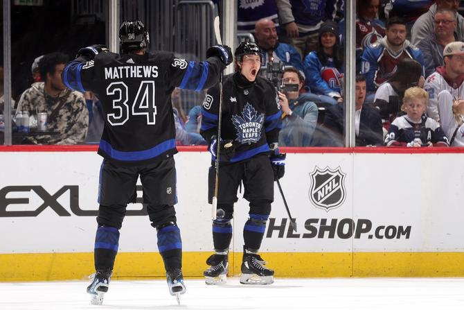 Auston Matthews #34 and Tyler Bertuzzi #59 of the Toronto Maple Leafs celebrate Bertuzzi's hat trick in the third period against the Colorado Avalanche
