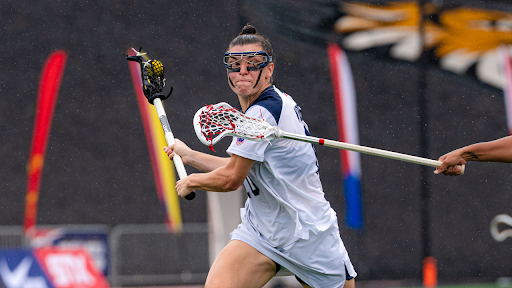 Women’s lacrosse player competes in match.
