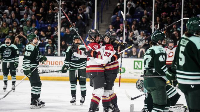 Ottawa Charge players embrace.