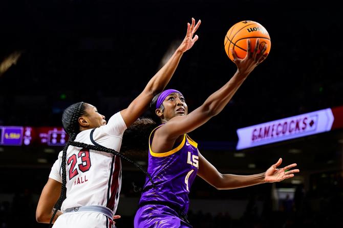 LSU’s Flau’jae Johnson attempts a layup around a South Carolina player.
