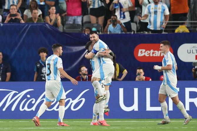 Lionel Messi of Argentina celebrates with teammate Enzo Fernandez.