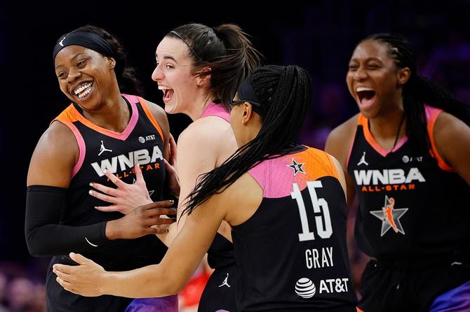 Arike Ogunbowale #24 celebrates a three point basket with Caitlin Clark #22 and Allisha Gray #15 of Team WNBA in the second half against Team USA during the 2024 WNBA All Star Game at Footprint Center on July 20, 2024 in Phoenix, Arizona. Team WNBA beat Team USA 117-109.