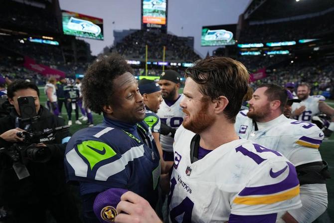 Former Seattle Seahawks quarterback Geno Smith shakes hands with former Minnesota Vikings quarterback Sam Darnold after a game.