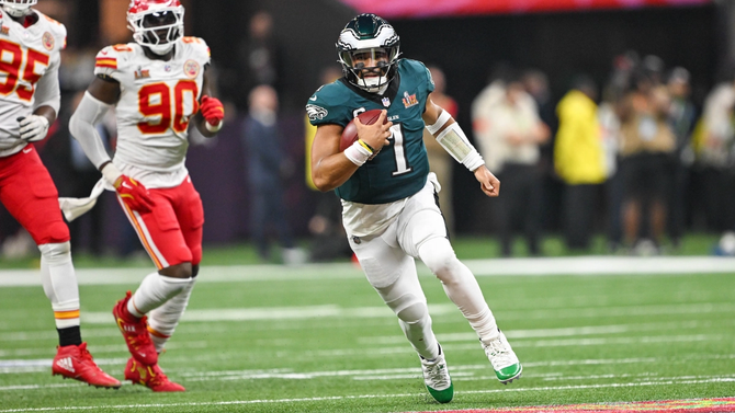 Jalen Hurts carrying the football on the field during the Super Bowl