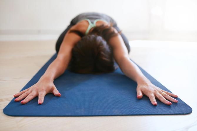 A woman doing yoga on a mat