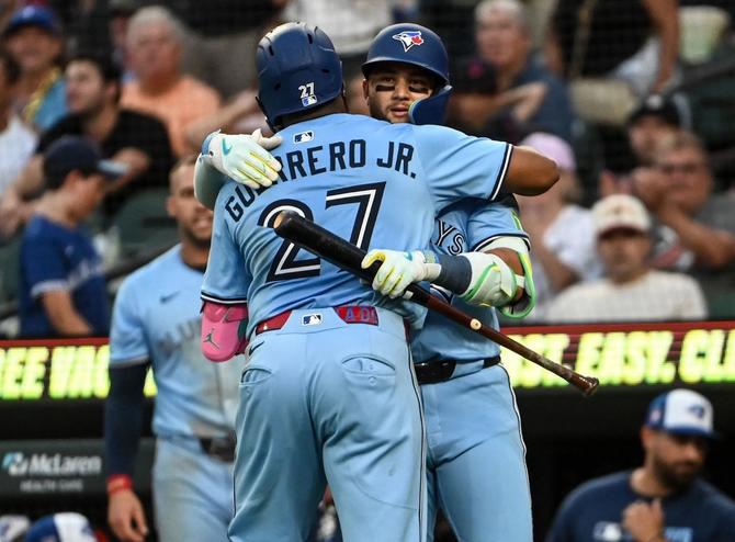 Toronto Blue Jays Vladimir Guerrero Jr. and Bo Bichette embrace at home plate.