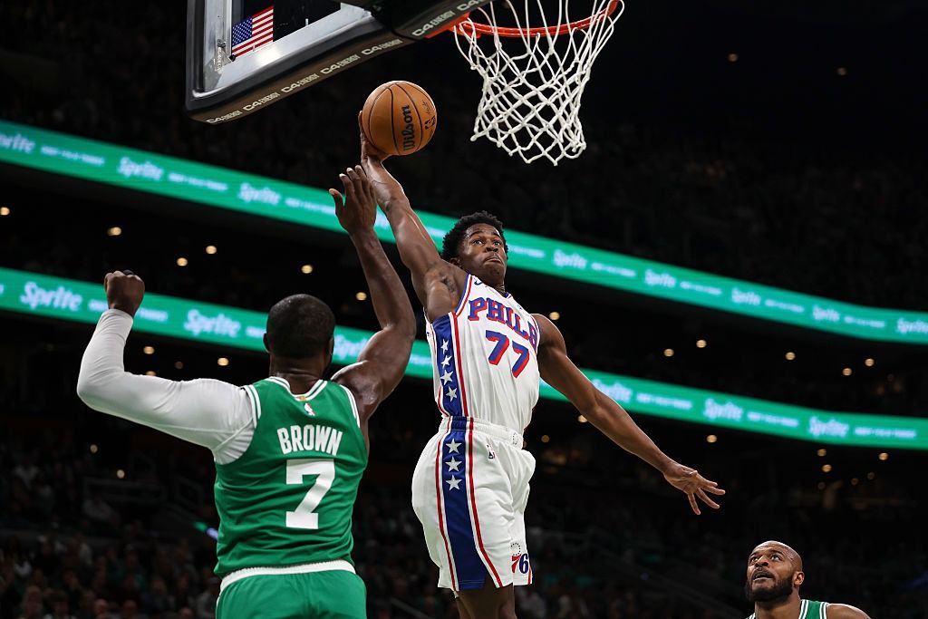 Philadelphia 76er V.J. Edgecombe dunks on Boston Celtic Jaylen Brown.