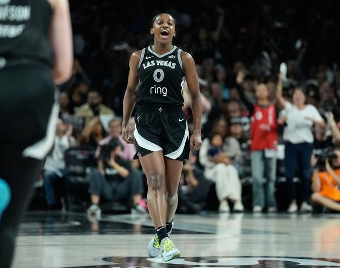Las Vegas Ace Jackie Young yells in celebration while jogging up the court.