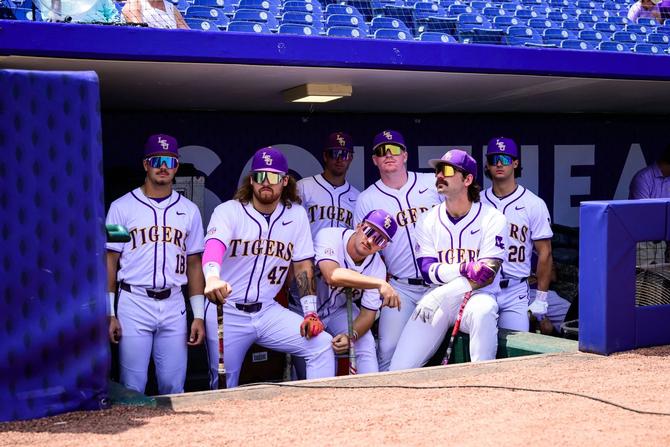 Members of the LSU baseball team look on from the dugout