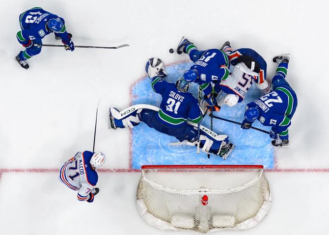 Arturs Silovs #31 of the Vancouver Canucks makes a save against Dylan Holloway #55 of the Edmonton Oilers during the 3rd period in Game One of the Second Round of the 2024 Stanley Cup Playoffs