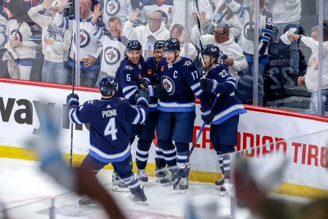 Neal Pionk #4, Brenden Dillon #5, Nino Niederreiter #62, Adam Lowry #17 and Mason Appleton #22 of the Winnipeg Jets celebrate a second period goal against the Colorado Avalanche