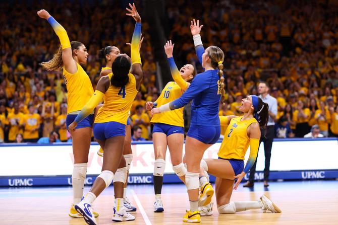 The Pitt Volleyball team celebrating on the court