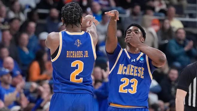 Members of the McNeese State men’s basketball team celebrate as their team upsets Clemson during March Madness.