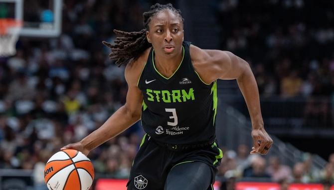 WNBPA President and Seattle Storm star Nneka Ogqumike dribbles the ball up the court.
