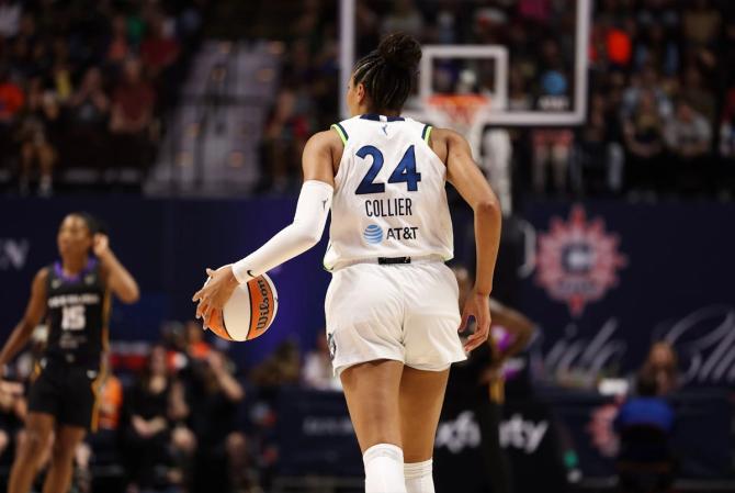 Minnesota Lynx Napheesa Collier dribbles the ball up the court.