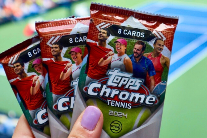 A fan holding packs of Topps cards