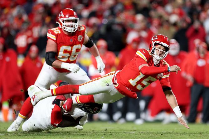 Kansas City Chiefs quarterback Patrick Mahomes throws the ball as he is tackled.