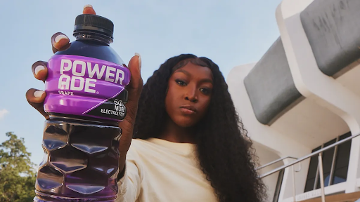 LSU basketball star Flau’jae Johnson poses with a Powerade bottle following the announcement of her partnership with the brand in 2024.