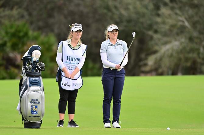 Brooke M. Henderson of Canada stands with caddie Brittany Henderson before her shot on the eighth hole