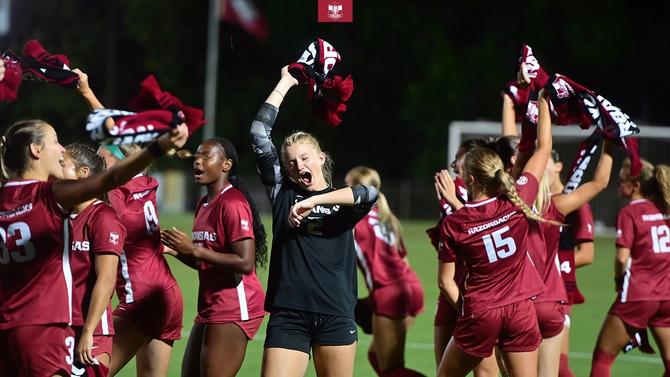 The Arkansas women’s soccer team shows off their team scarves.