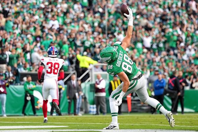 Philadelphia Eagles tight end Dallas Goeddert spikes the ball after scoring a touchdown.