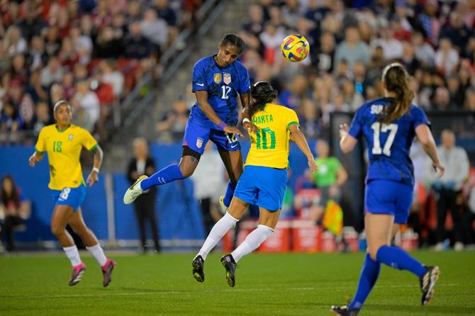 Naomi Girma #12 of the United States heads a ball above Marta #10 of Brazil.