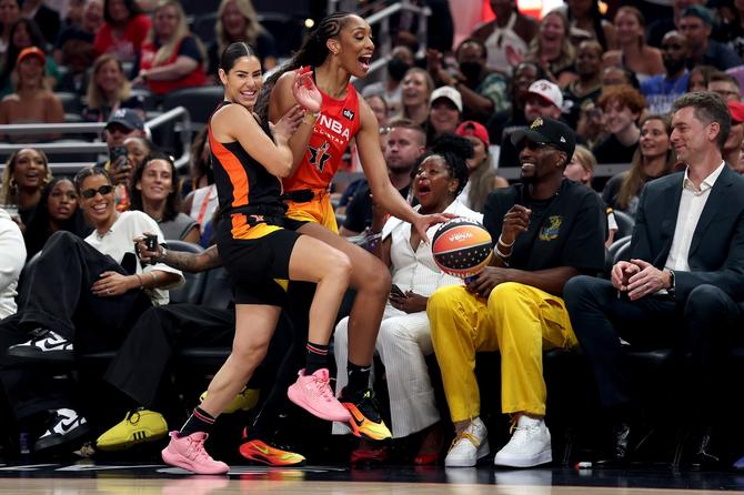 Kelsey Plum smiling while fouling A'ja Wilson during the WNBA All-Star Game