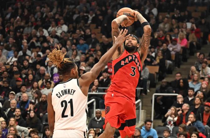 Toronto Raptor Brandon Ingram shoots the ball over a defender.