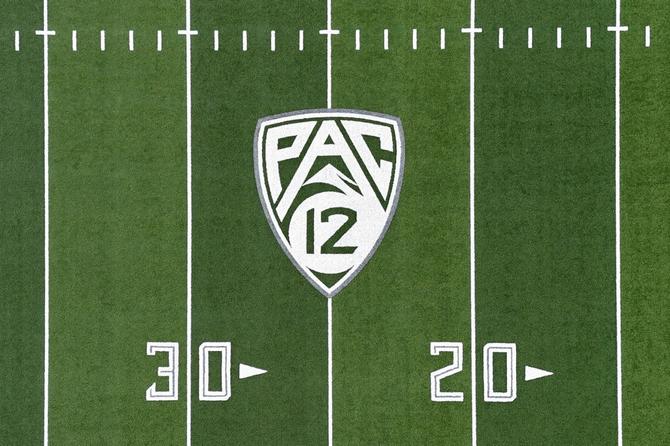 The Pac-12 logo on a football field.