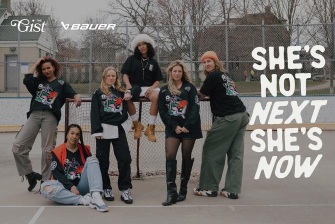 A group of women posing together by a hockey goal
