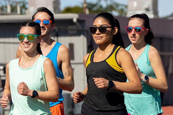 A group of people running and wearing goodr sunglasses