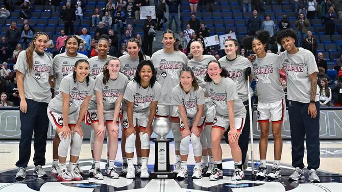 The UConn women’s basketball team poses with their Big East championship trophy.