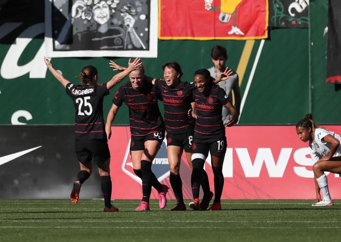 Hina Sugita #8 of Portland Thorns FC, center, celebrates after scoring a goal against the NJ/NY Gotham FC with Meghan Klingenberg #25, Hannah Betfort #33, and Crystal Dunn #19 during the second half at Providence Park on October 07, 2023 in Portland, Oregon.