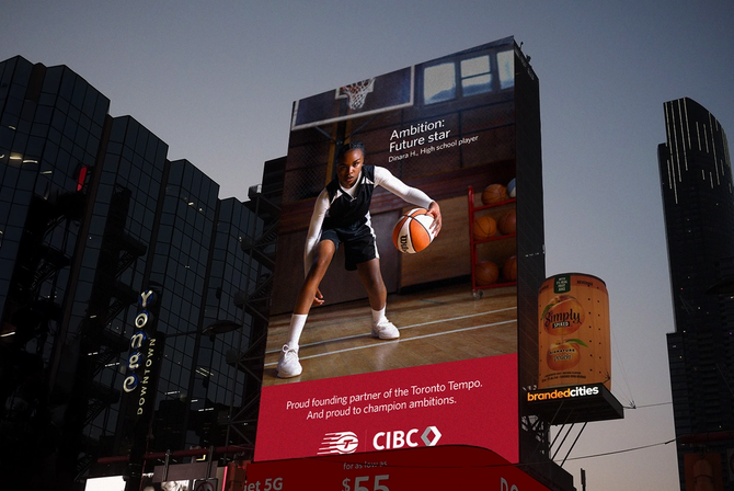 A billboard of a girl dribbling a basketball