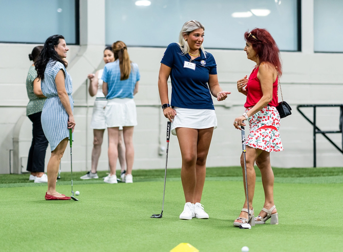 A golf pro giving golf lessons
