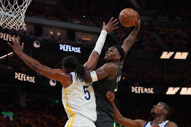 Minnesota’s Anthony Edwards dunks on Golden State’s Kevon Looney.