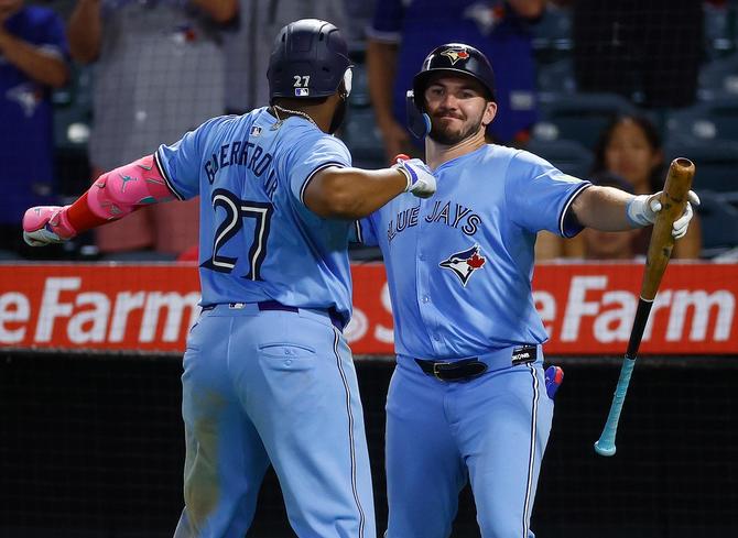 Vladimir Guerrero Jr. #27 and Spencer Horwitz #48 of the Toronto Blue Jays celebrate a two-run home run against the Los Angeles Angels