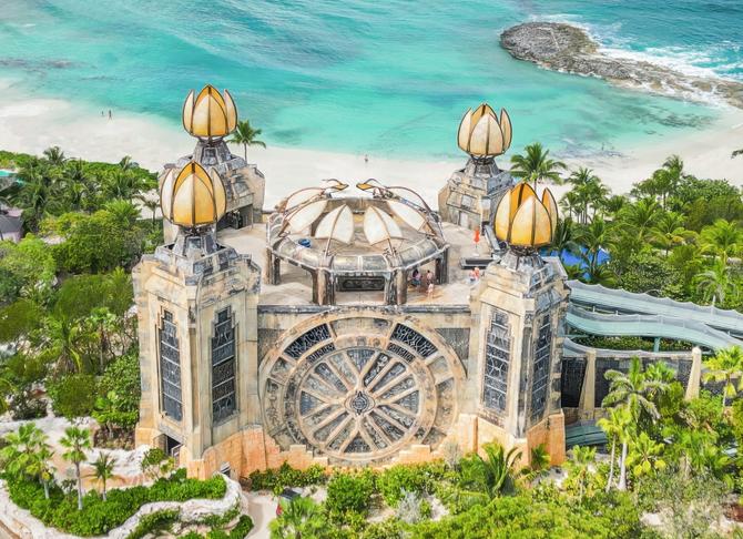 Exterior of Atlantis resort in the Bahamas, surrounded by beach, ocean, and greenery