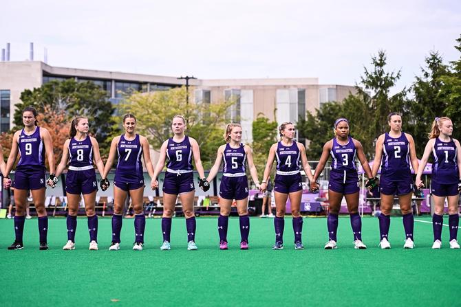 The top-ranked Northwestern field hockey team holds hands during a pre-game ceremony.