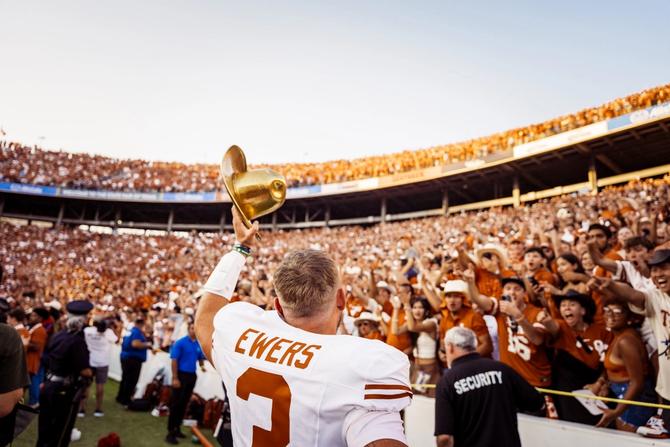 Texas football quarterback Quinn Ewers celebrates with fans.