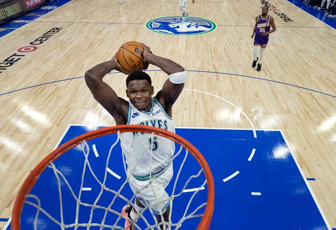 The Minnesota Timberwolves’ Anthony Edwards elevates to dunk the ball during a game.