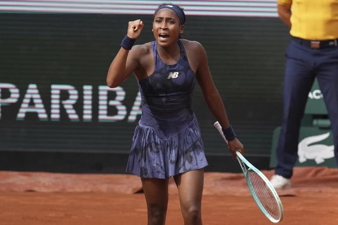 Coco Gauff celebrates after notching a point at the French Open.