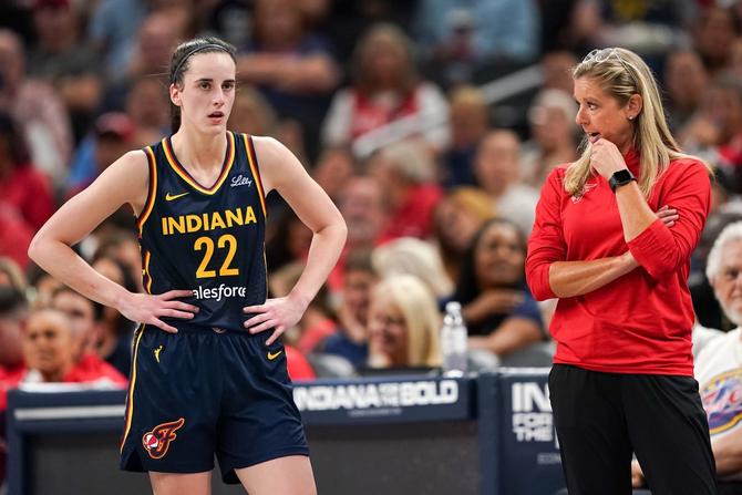 Indiana Fever rookie Caitlin Clark stands next to head coach Christie Sides.