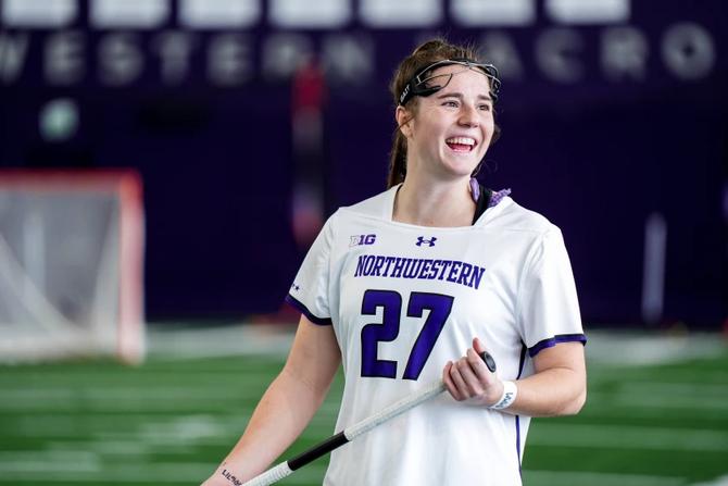 No. 1 Northwestern women’s lacrosse superstar Izzy Scane smiles at her teammates during a home game.