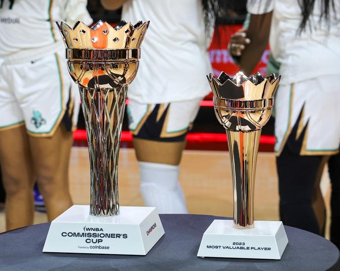 The WNBA Commissioner's Cup trophy and MVP trophy