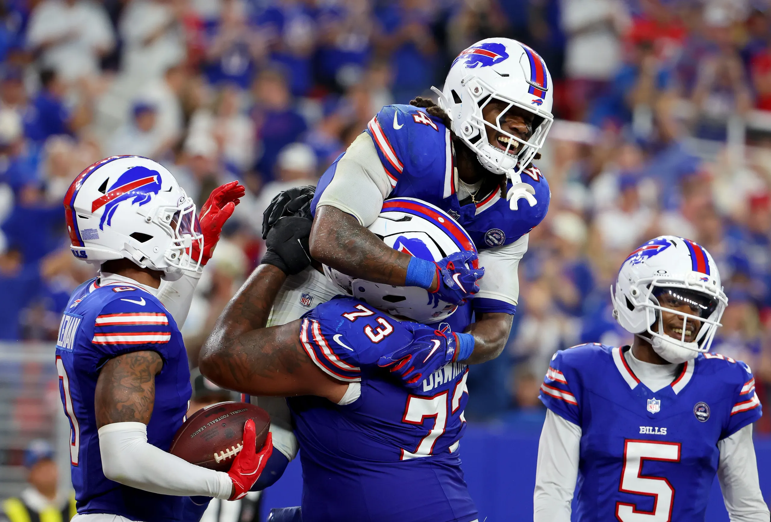 Buffalo Bills running back James Cook III celebrates a touchdown with teammates.