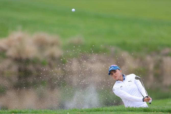 Lexi Thompson of the United States plays a shot from a bunker on the third hole during the first round of the Cognizant Founders Cup