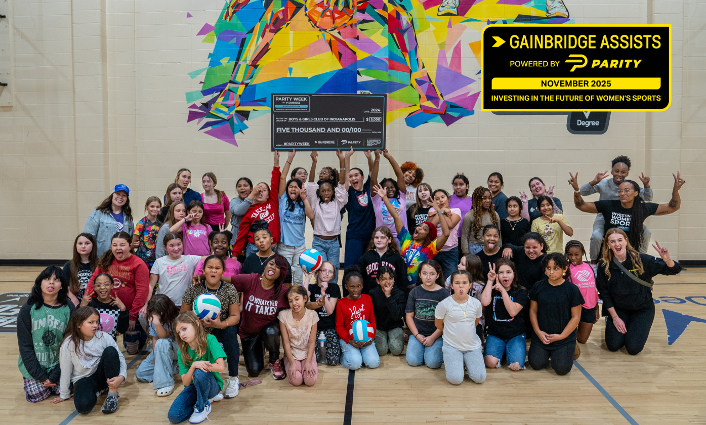A group of kids smiling while holding a big check