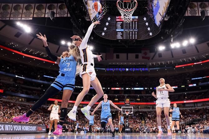 Sophie Cunningham #8 of the Indiana Fever is fouled by DiJonai Carrington #7 of the Chicago Sky during the first half at United Center on August 08, 2026 in Chicago, Illinois.